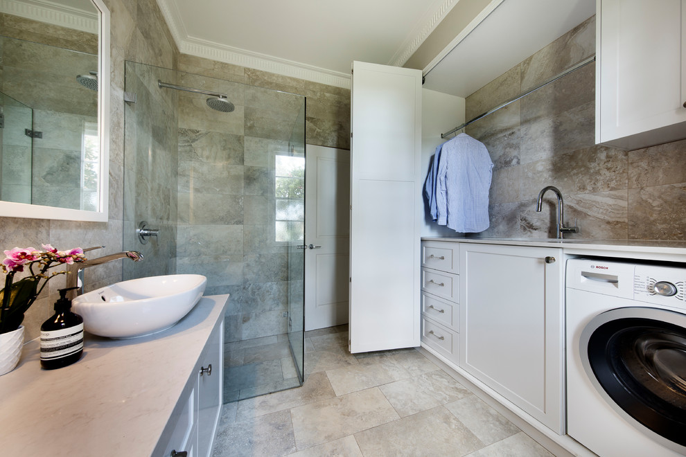 Photo of a large transitional kids bathroom in Sydney with shaker cabinets, white cabinets, a curbless shower, a one-piece toilet, beige tile, porcelain tile, porcelain floors, a vessel sink, engineered quartz benchtops, beige floor, a hinged shower door and beige benchtops.
