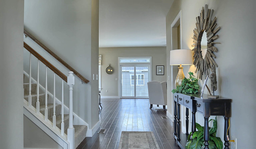 Inspiration for a mid-sized arts and crafts foyer in Other with dark hardwood floors and beige walls.