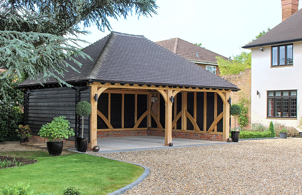 Design ideas for a mid-sized traditional detached two-car carport in Gloucestershire.