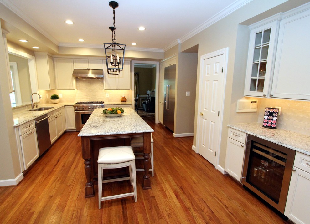 Inspiration for a mid-sized transitional u-shaped medium tone wood floor open concept kitchen remodel in DC Metro with an undermount sink, recessed-panel cabinets, white cabinets, quartz countertops, white backsplash, glass tile backsplash, stainless steel appliances and an island