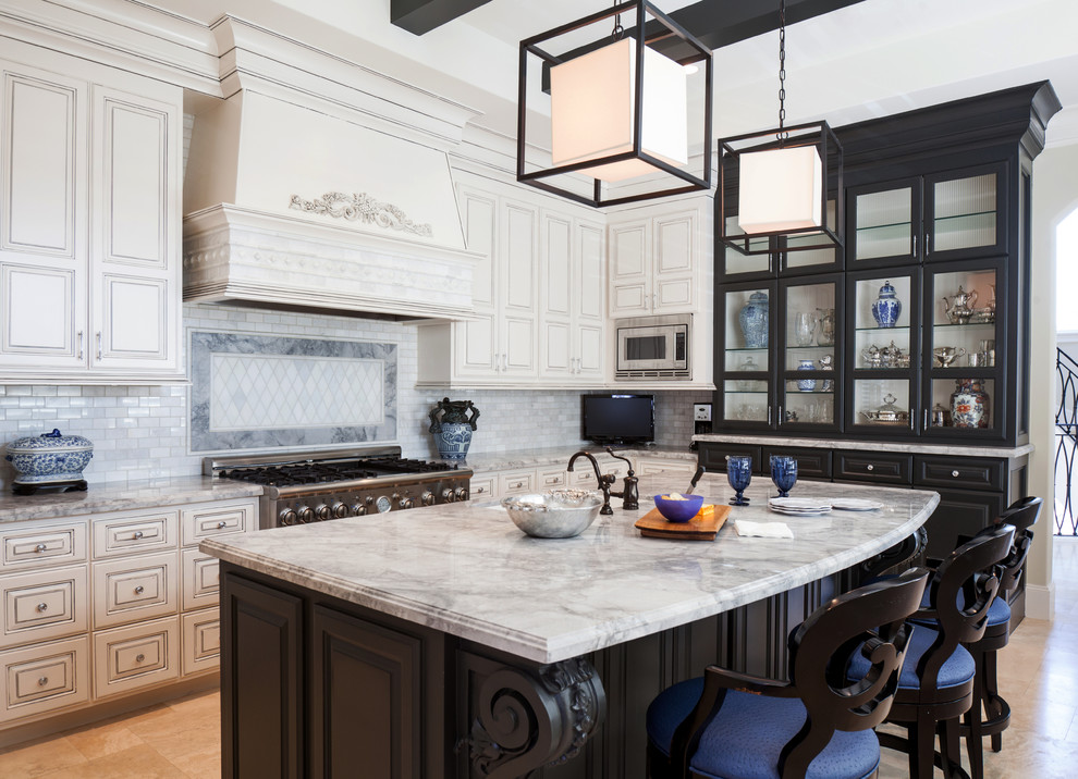Large transitional u-shaped eat-in kitchen in Houston with a farmhouse sink, glass-front cabinets, black cabinets, quartzite benchtops, white splashback, stone tile splashback, stainless steel appliances and travertine floors.