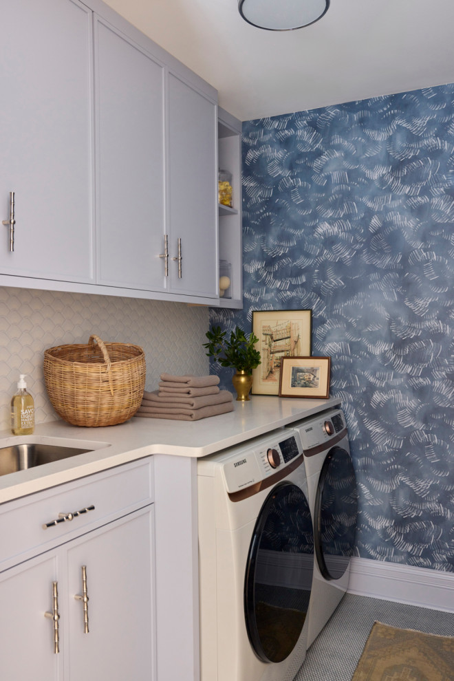 Example of a transitional single-wall wallpaper laundry room design in Chicago with an undermount sink, shaker cabinets, blue walls, a side-by-side washer/dryer and white countertops