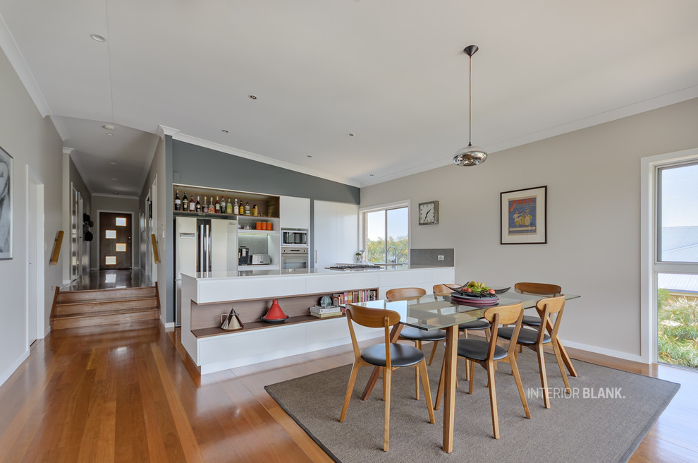 This is an example of a mid-sized modern open plan dining in Gold Coast - Tweed with medium hardwood floors.