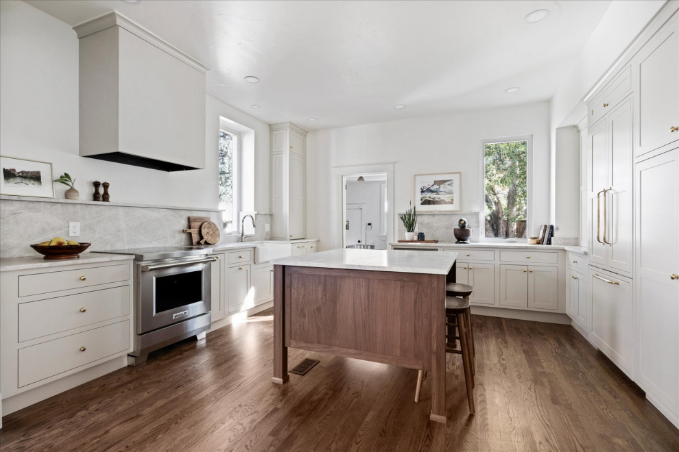 Mid-sized transitional medium tone wood floor and brown floor eat-in kitchen photo in Denver with white walls and a standard fireplace