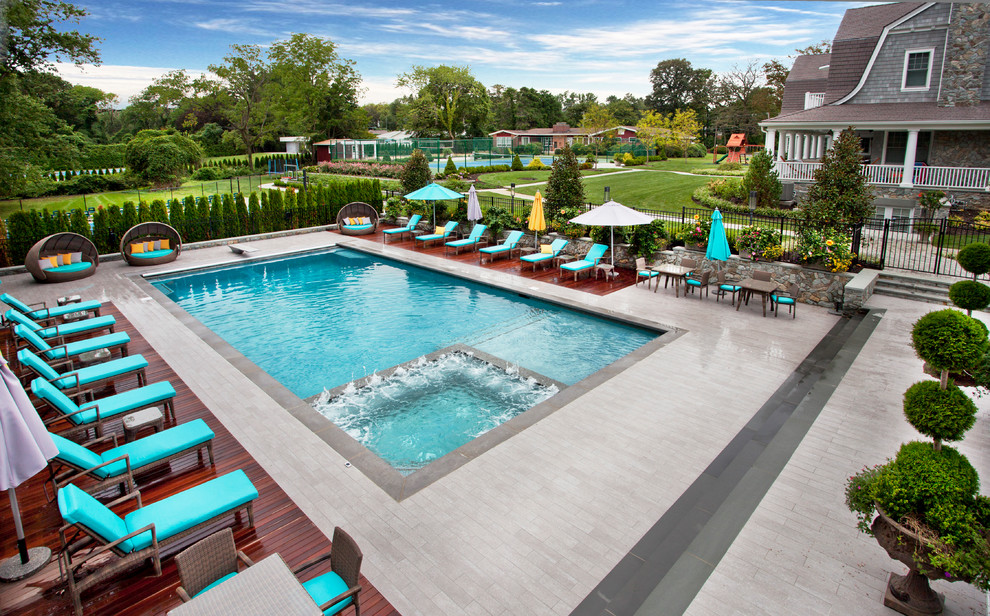 Design ideas for a large contemporary backyard rectangular pool in New York with concrete pavers.