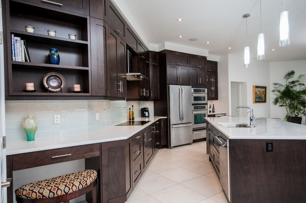 Enclosed kitchen - mid-sized transitional single-wall porcelain tile enclosed kitchen idea in Toronto with an undermount sink, shaker cabinets, dark wood cabinets, white backsplash, subway tile backsplash, stainless steel appliances, an island and solid surface countertops