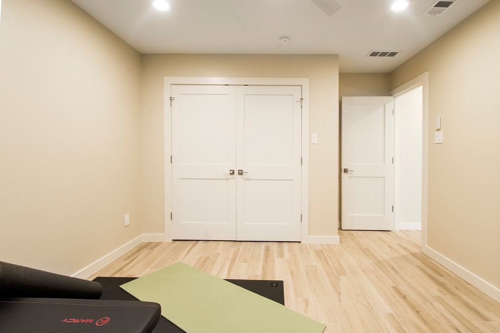 Inspiration for a large transitional multipurpose gym in Dallas with beige walls, light hardwood floors and beige floor.