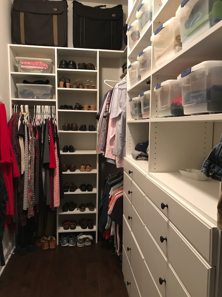Photo of a mid-sized traditional gender-neutral walk-in wardrobe in Other with flat-panel cabinets, white cabinets, medium hardwood floors and brown floor.