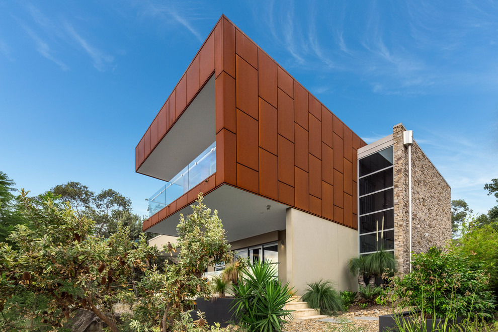 Inspiration for a large contemporary three-storey exterior in Sydney with metal siding and a flat roof.