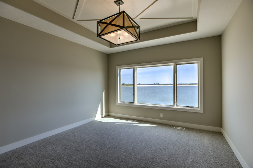 Beach style master bedroom in Omaha with carpet.