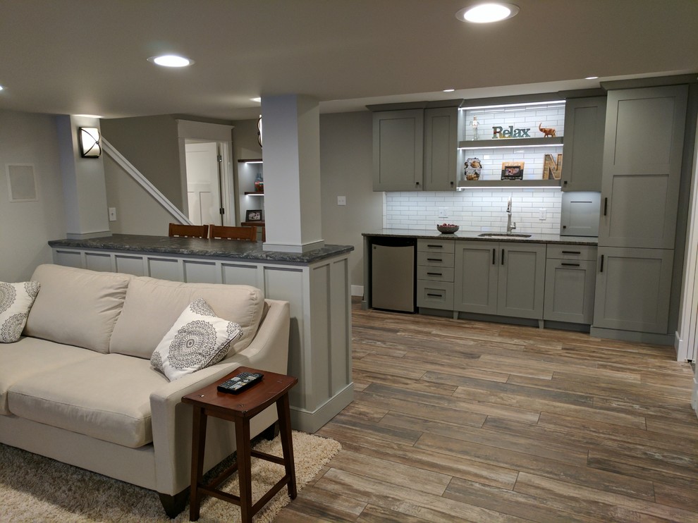 Mid-sized transitional look-out porcelain tile basement photo in Other with gray walls