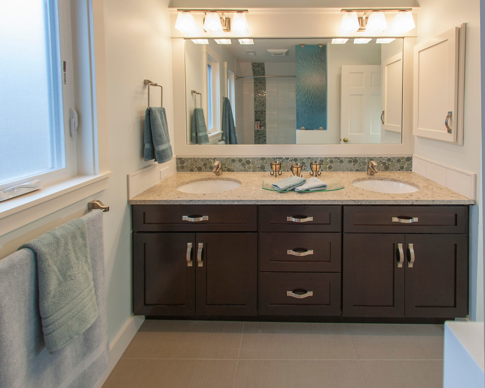 Example of a transitional blue tile and glass sheet porcelain tile tub/shower combo design in Seattle with an undermount sink, shaker cabinets, dark wood cabinets, quartzite countertops, a one-piece toilet and white walls