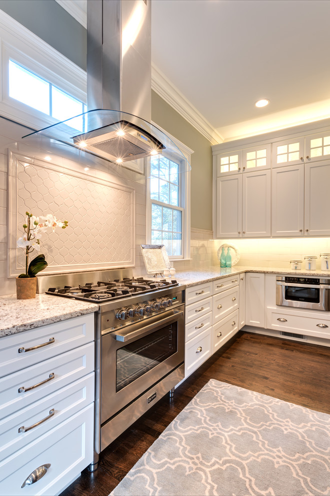 Example of a huge transitional l-shaped dark wood floor and brown floor eat-in kitchen design in Atlanta with an undermount sink, recessed-panel cabinets, white cabinets, granite countertops, gray backsplash, porcelain backsplash, stainless steel appliances, an island and white countertops