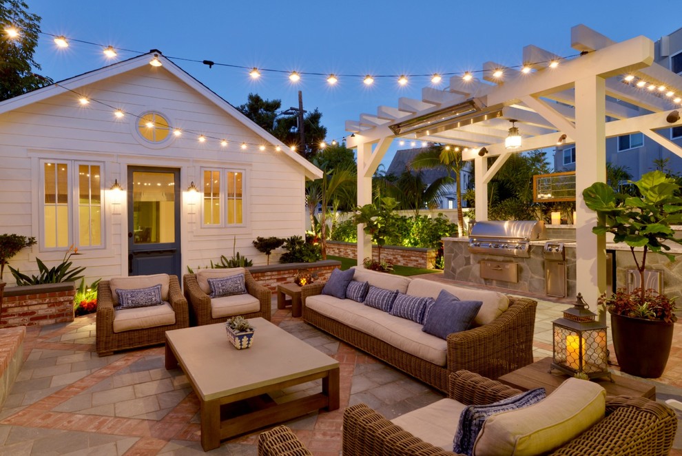 Small beach style backyard patio in San Diego with an outdoor kitchen, tile and a gazebo/cabana.