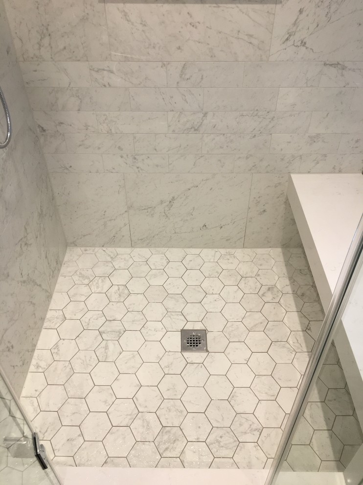 Photo of a large traditional master bathroom in Toronto with a corner shower, white tile, porcelain tile, a hinged shower door, recessed-panel cabinets, distressed cabinets, a drop-in tub, a one-piece toilet, grey walls, porcelain floors, an undermount sink, engineered quartz benchtops, grey floor and white benchtops.