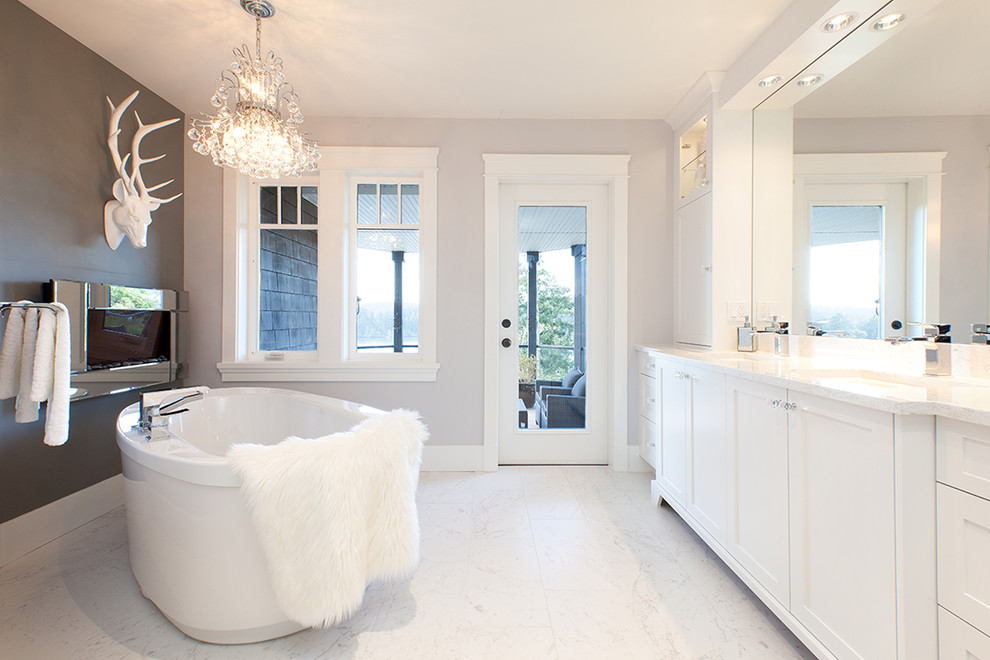 Photo of a mid-sized contemporary master bathroom in Vancouver with shaker cabinets, white cabinets, quartzite benchtops, a freestanding tub, a corner shower, a one-piece toilet, white tile, porcelain tile, grey walls and porcelain floors.