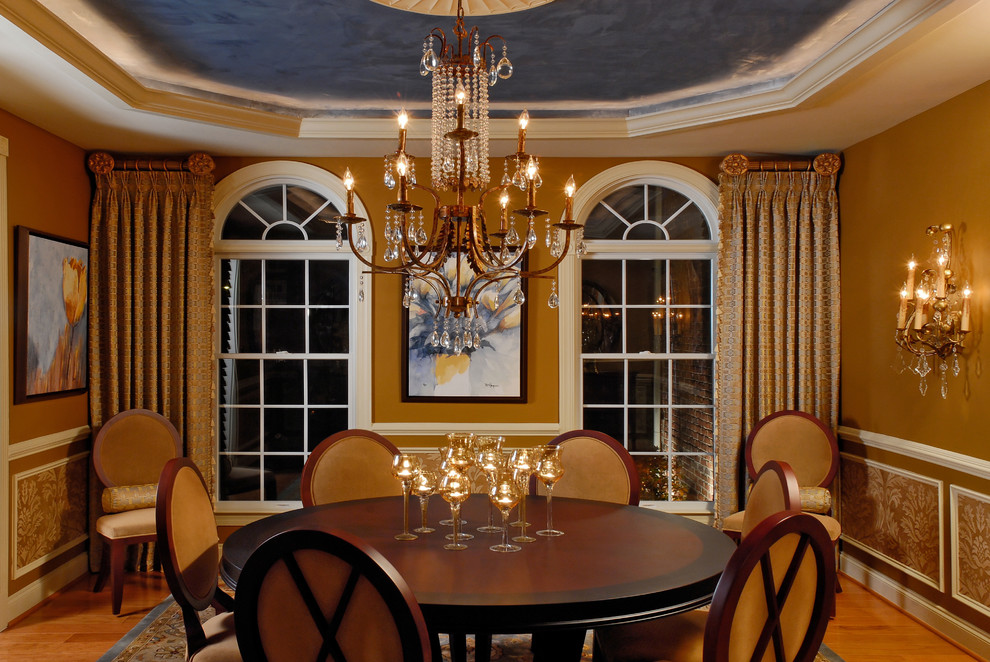 Photo of a traditional separate dining room in DC Metro with brown walls and dark hardwood floors.