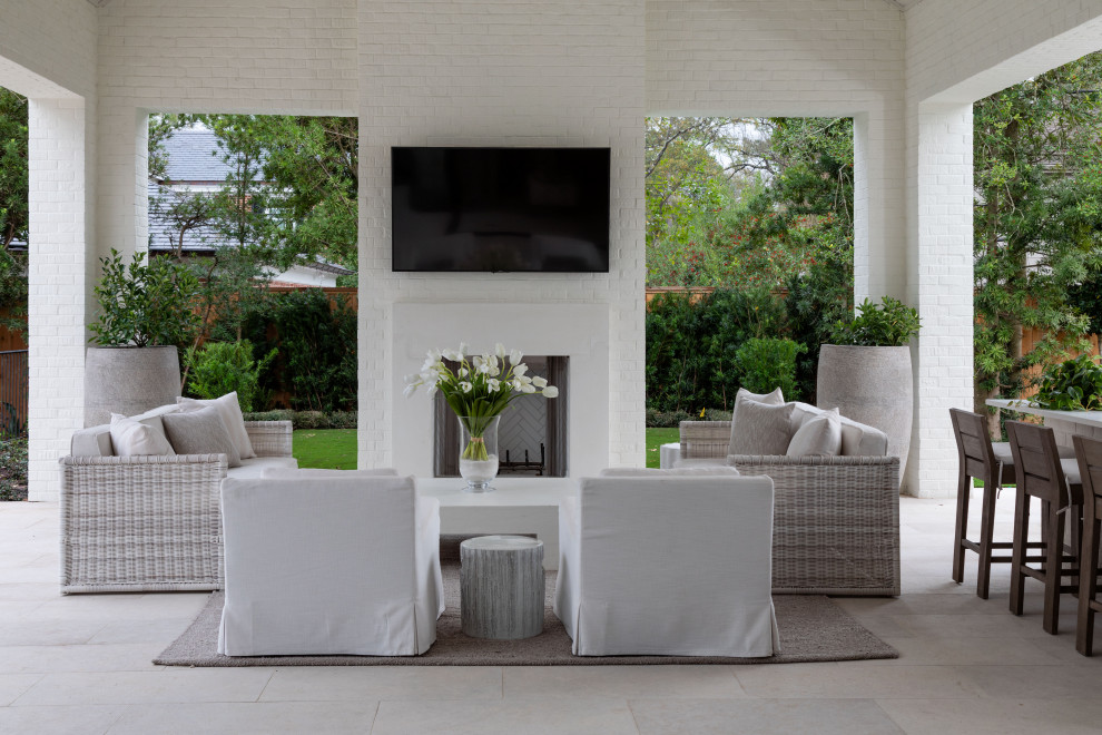 Inspiration for an expansive transitional backyard patio in Houston with with fireplace, a roof extension and tile.