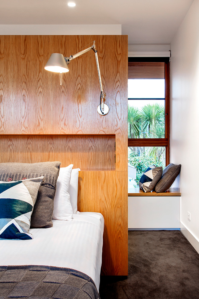 Inspiration for a large modern master bedroom in Melbourne with white walls and carpet.