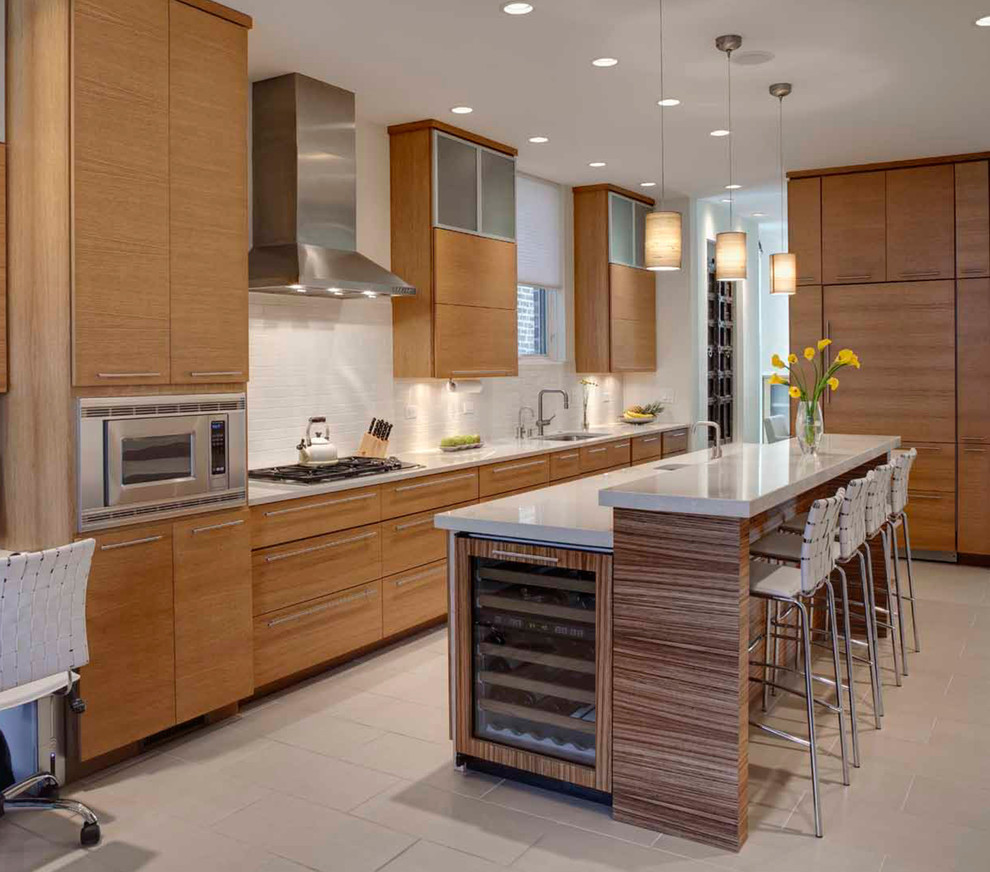 Inspiration for a mid-sized contemporary l-shaped kitchen in Chicago with flat-panel cabinets, medium wood cabinets, white splashback, stainless steel appliances, with island, an undermount sink, ceramic floors, beige floor and solid surface benchtops.