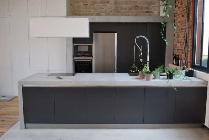 Photo of a large contemporary galley open plan kitchen in Paris with concrete benchtops.