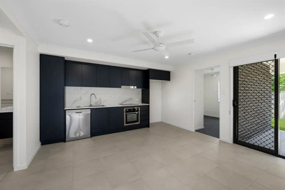 Design ideas for a small contemporary single-wall eat-in kitchen in Sydney with a single-bowl sink, flat-panel cabinets, black cabinets, marble benchtops, multi-coloured splashback, marble splashback, stainless steel appliances, ceramic floors, no island, grey floor and multi-coloured benchtop.