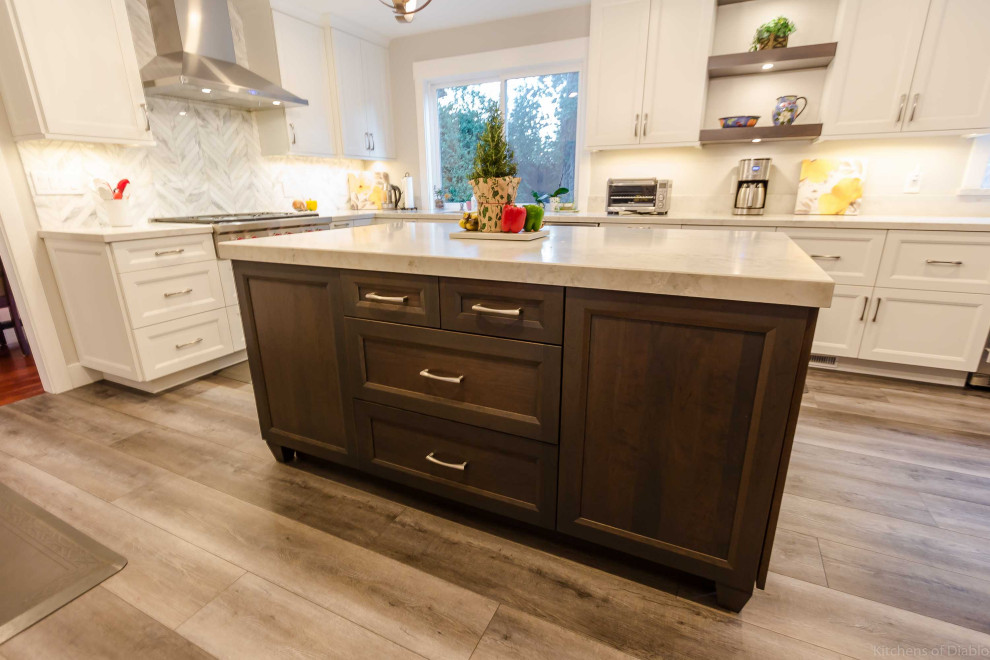 Inspiration for a large transitional u-shaped medium tone wood floor and gray floor open concept kitchen remodel in San Francisco with an undermount sink, recessed-panel cabinets, white cabinets, quartz countertops, white backsplash, marble backsplash, stainless steel appliances, an island and white countertops