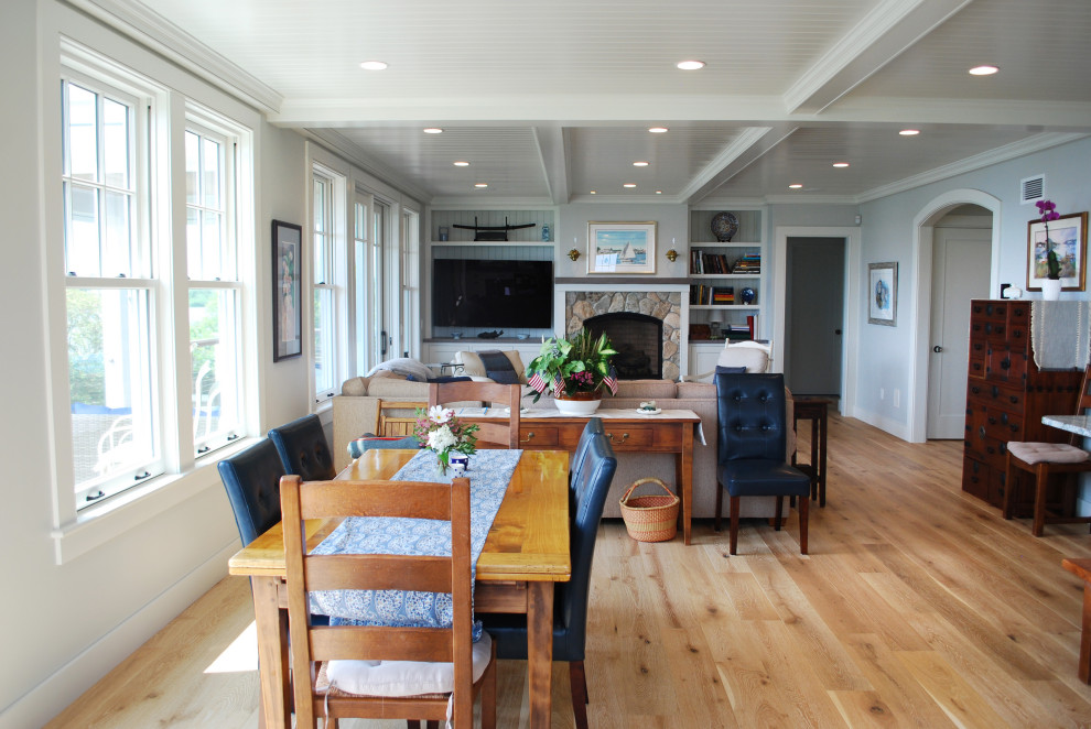 Dining room - large coastal shiplap ceiling dining room idea in Providence with blue walls, a standard fireplace and a stone fireplace