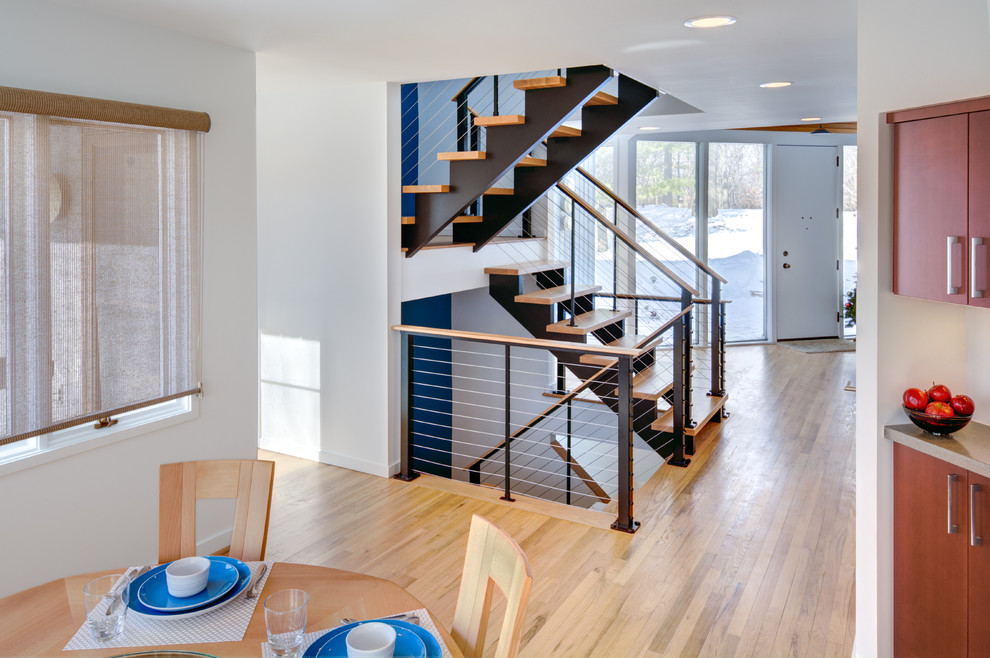 This is an example of a large contemporary wood floating staircase in Detroit with open risers.