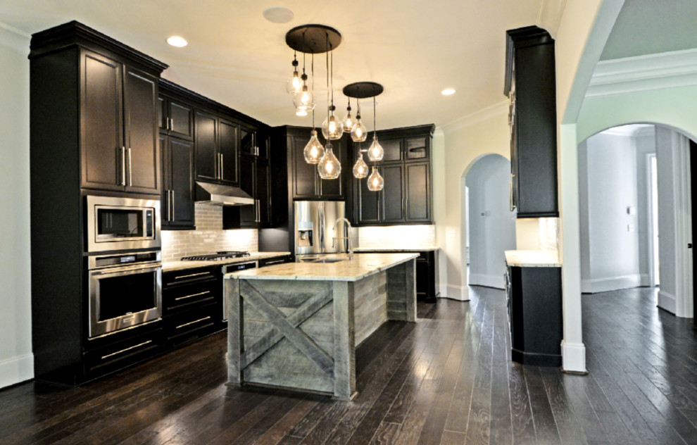 Enclosed kitchen - mid-sized transitional u-shaped dark wood floor and brown floor enclosed kitchen idea with a farmhouse sink, recessed-panel cabinets, dark wood cabinets, granite countertops, gray backsplash, subway tile backsplash, stainless steel appliances and an island