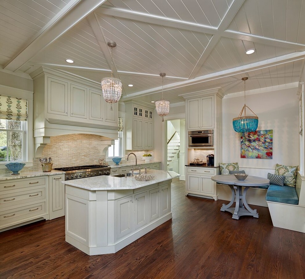 This is an example of an expansive beach style single-wall eat-in kitchen in Charleston with an undermount sink, recessed-panel cabinets, white cabinets, marble benchtops, multi-coloured splashback, stainless steel appliances, dark hardwood floors, with island and matchstick tile splashback.