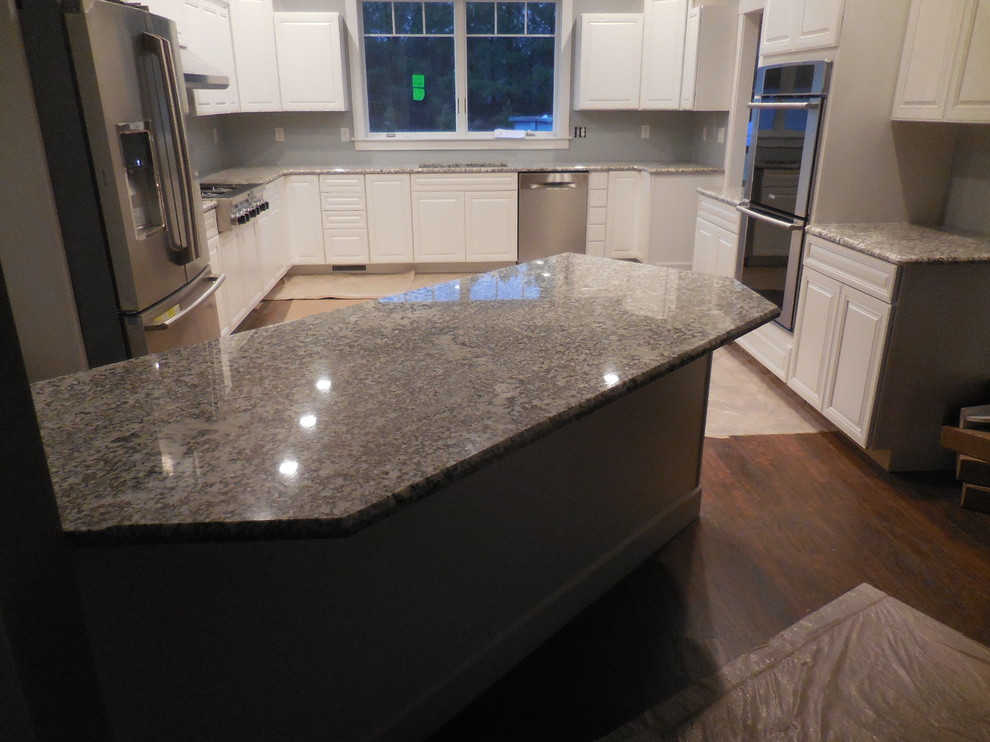 Example of a mid-sized transitional u-shaped medium tone wood floor kitchen design in Baltimore with an undermount sink, raised-panel cabinets, white cabinets, granite countertops and stainless steel appliances