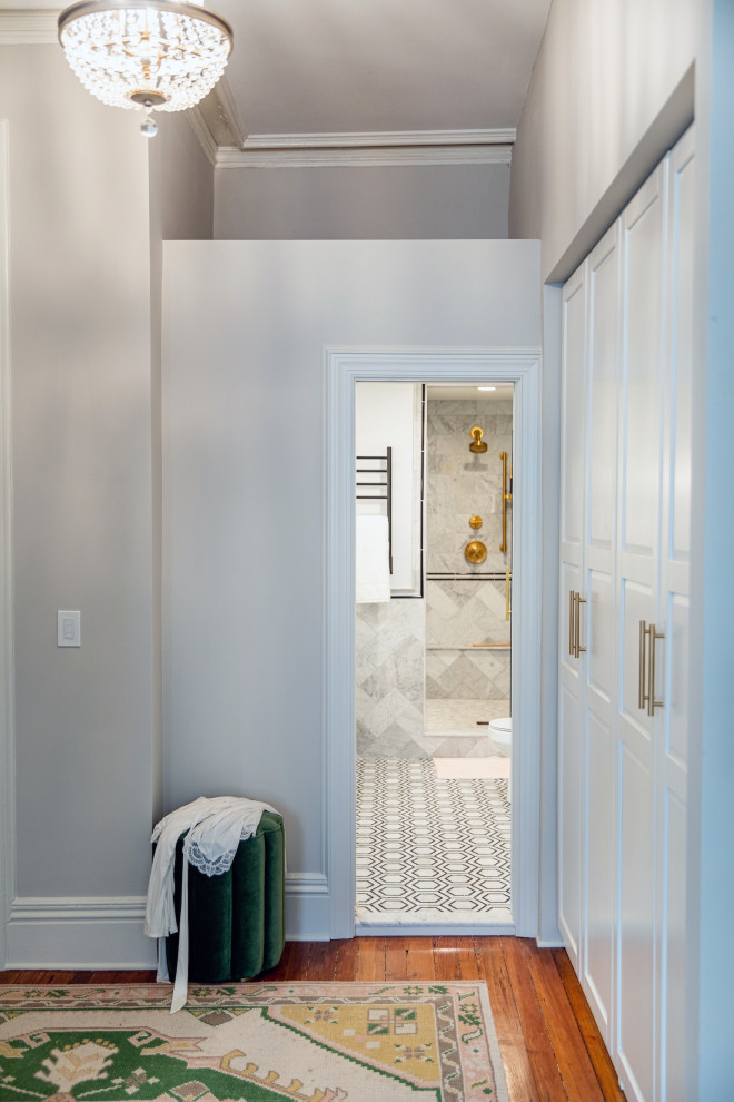 Design ideas for a traditional master bathroom in Baltimore with beaded inset cabinets, white cabinets, an alcove shower, marble, marble floors, a hinged shower door, white benchtops, a shower seat, a double vanity, a freestanding vanity and decorative wall panelling.