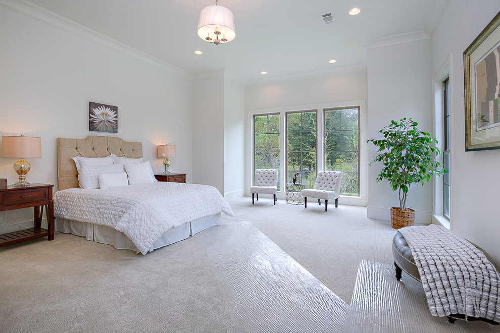 Large transitional master bedroom in New Orleans with white walls, carpet, no fireplace and beige floor.