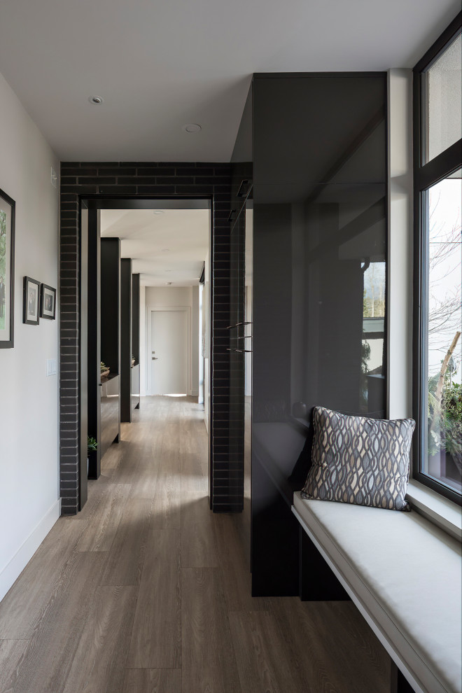 Design ideas for a contemporary hallway in Vancouver with brick walls.