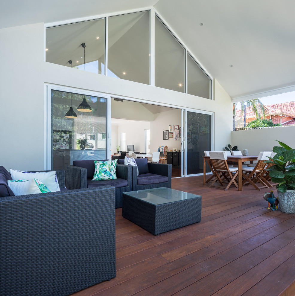 Contemporary backyard deck in Perth with a roof extension.