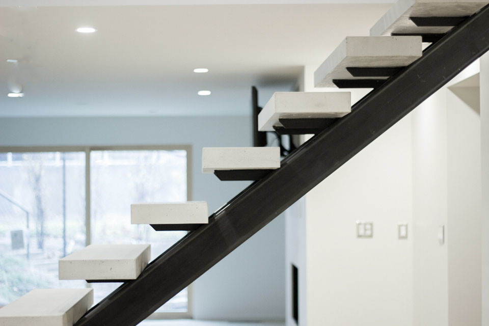 Inspiration for a large modern concrete floating staircase in Salt Lake City with open risers and metal railing.