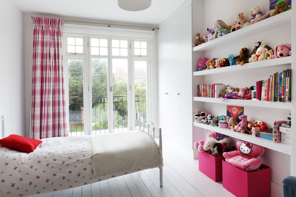 Inspiration for a transitional kids' bedroom for kids 4-10 years old and girls in London with painted wood floors, white floor and white walls.