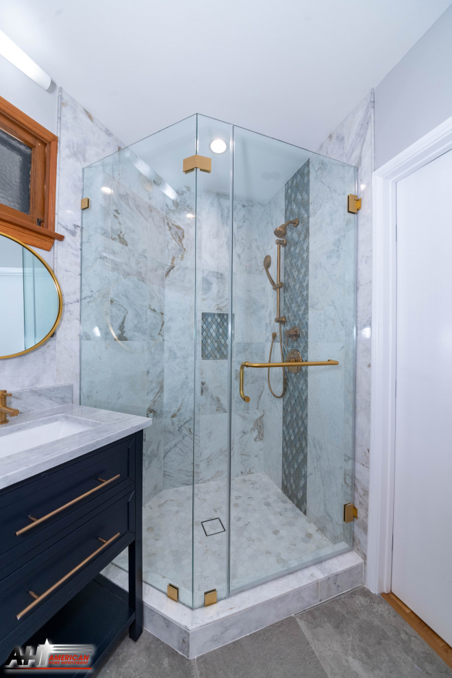 This is an example of a large modern master bathroom in Los Angeles with furniture-like cabinets, blue cabinets, a corner shower, a one-piece toilet, white tile, marble, white walls, porcelain floors, an undermount sink, marble benchtops, grey floor, a hinged shower door, white benchtops, a double vanity, a freestanding vanity and recessed.