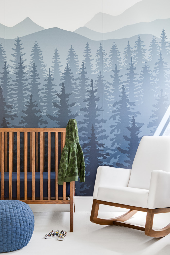 This is an example of a country nursery for boys in Orange County with blue walls and white floor.