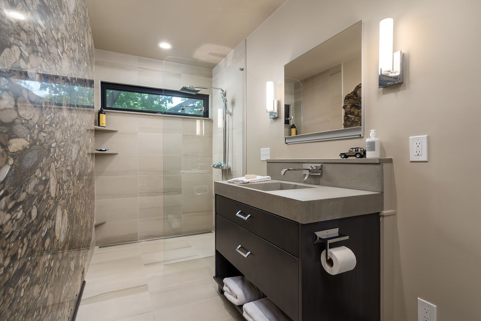 Small contemporary 3/4 wet room bathroom in Columbus with flat-panel cabinets, dark wood cabinets, a wall-mount toilet, beige tile, porcelain tile, beige walls, porcelain floors, an integrated sink, concrete benchtops, beige floor, an open shower and grey benchtops.
