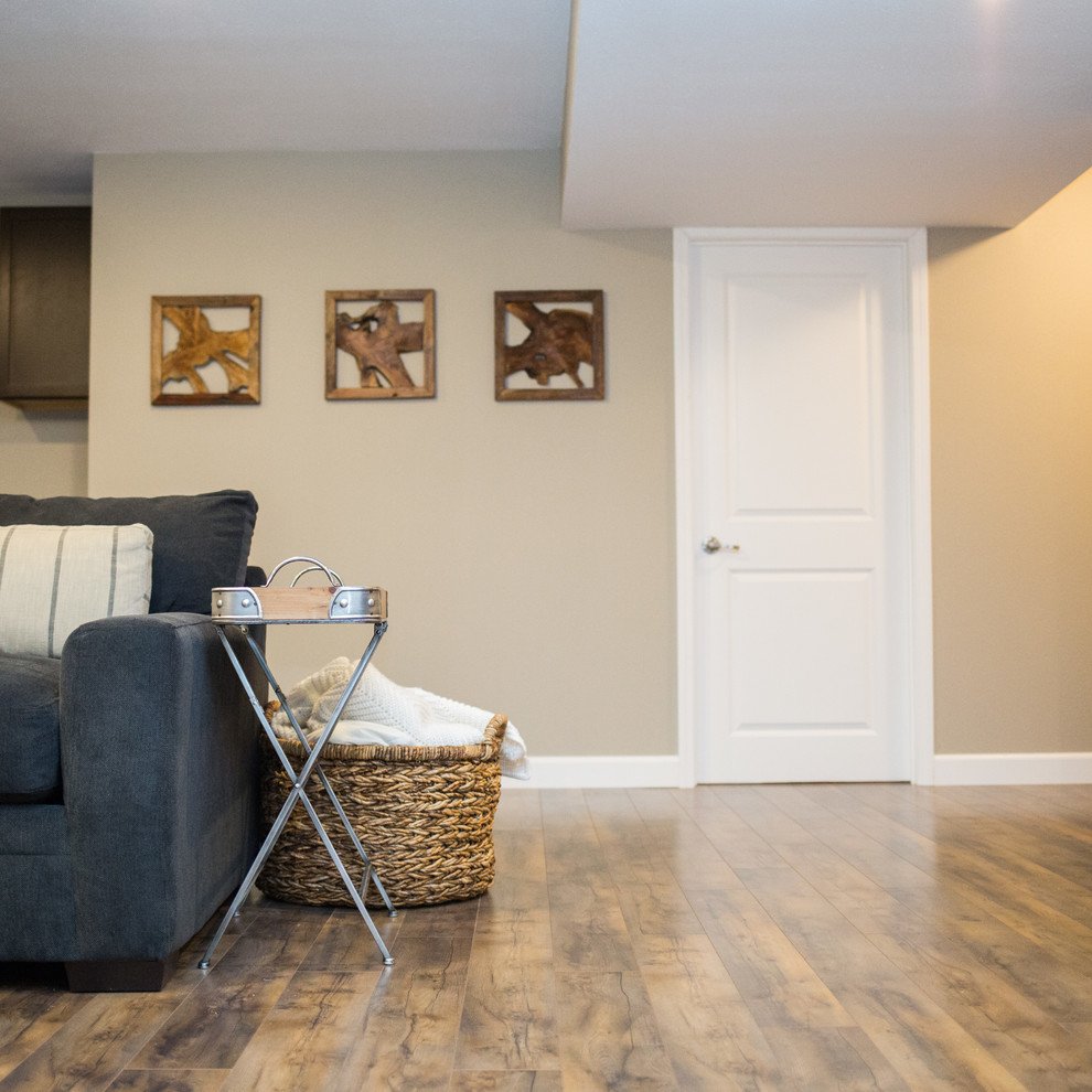 Mid-sized mountain style underground medium tone wood floor basement photo in St Louis with beige walls and no fireplace