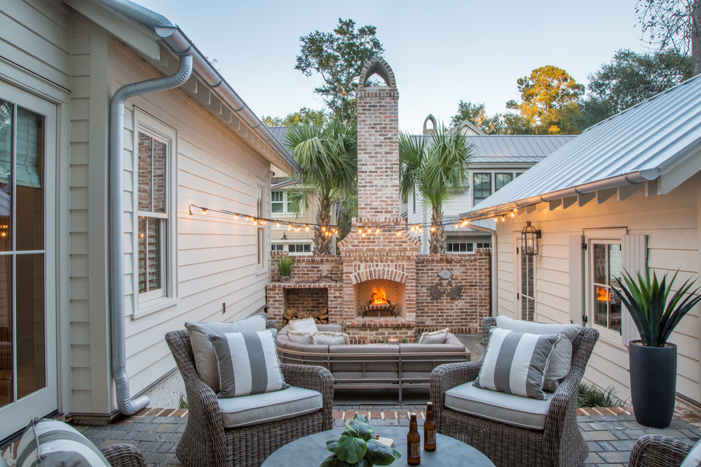 Inspiration for a country courtyard patio in Atlanta with brick pavers, no cover and with fireplace.