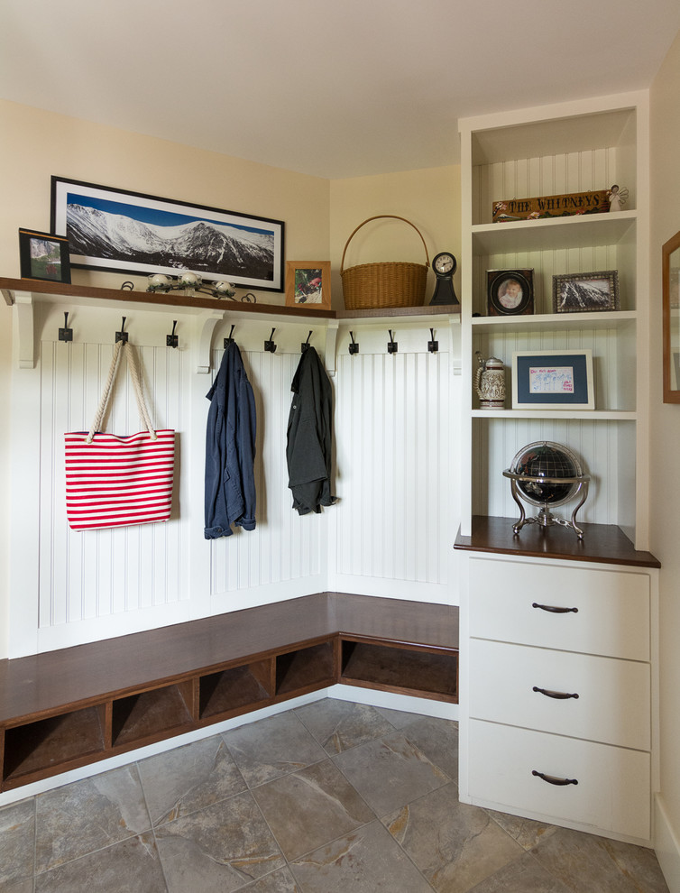 Design ideas for a mid-sized country mudroom in Portland Maine with beige walls, slate floors and brown floor.