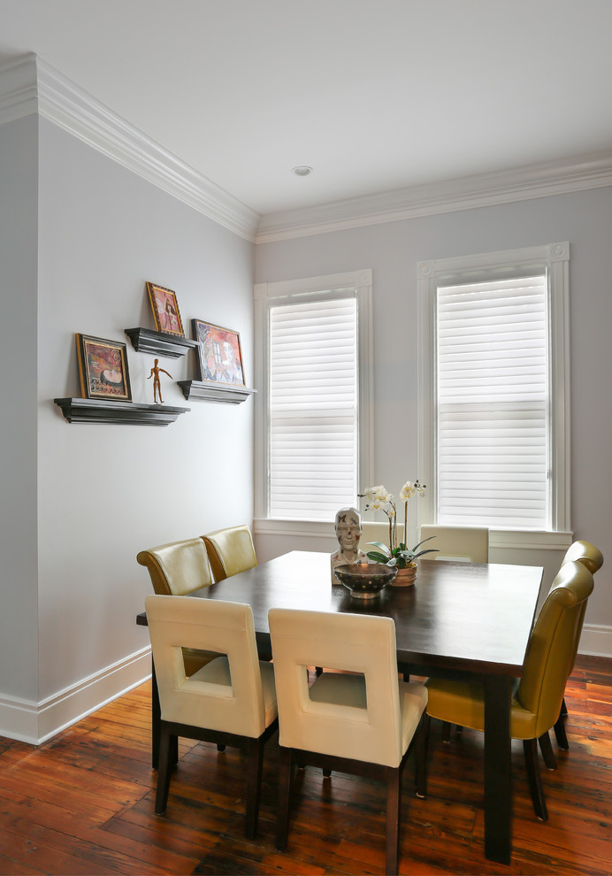 This is an example of a transitional dining room in Charleston with grey walls.