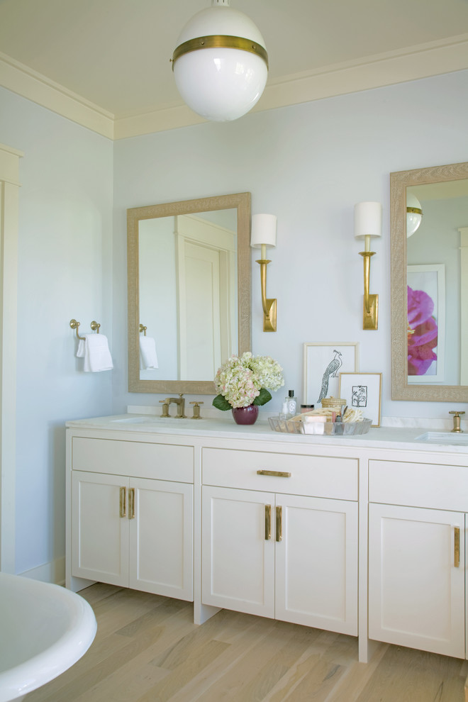 Photo of a tropical bathroom in Charleston with shaker cabinets and white cabinets.