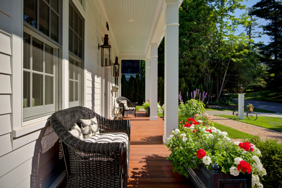 Large elegant back porch photo in New York with a fireplace and a pergola