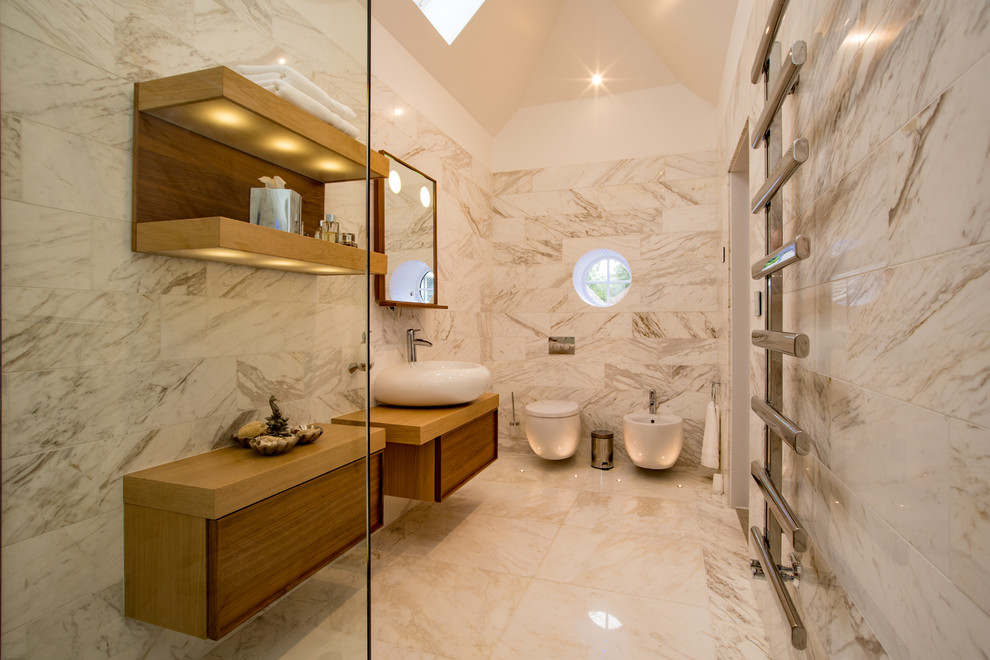 Inspiration for a large contemporary bathroom in Buckinghamshire with flat-panel cabinets, brown cabinets, grey tiles, white tiles, white walls, a vessel sink, white floors, brown worktops, marble tiles, marble flooring and a bidet.