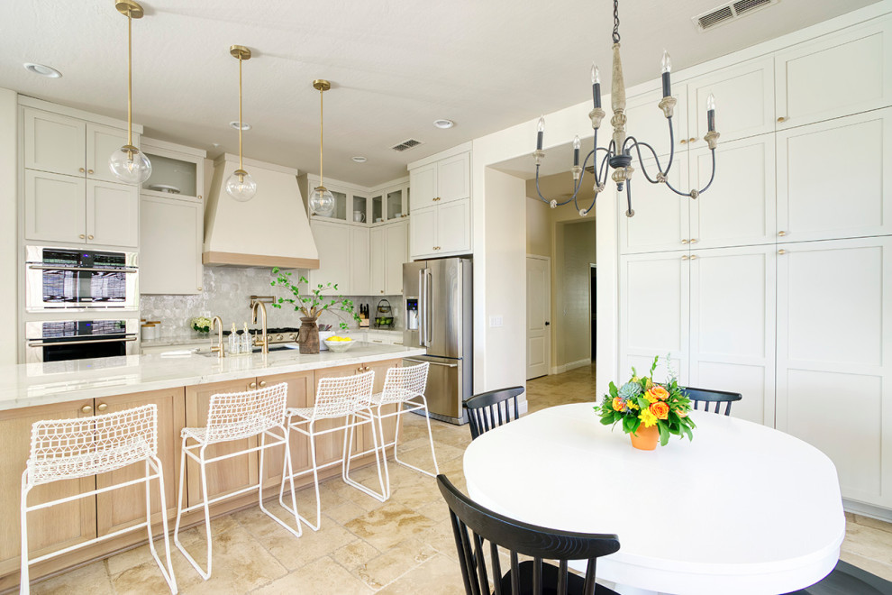 Example of a transitional limestone floor kitchen design in Phoenix with white cabinets and quartzite countertops