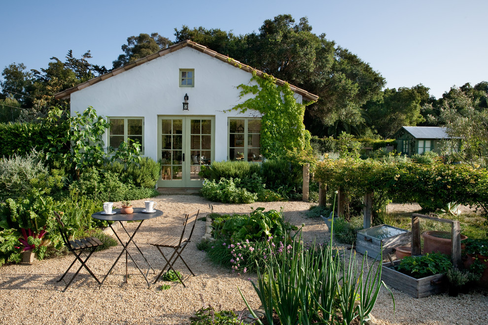 This is an example of a mediterranean backyard full sun garden in Santa Barbara with a vegetable garden and gravel.
